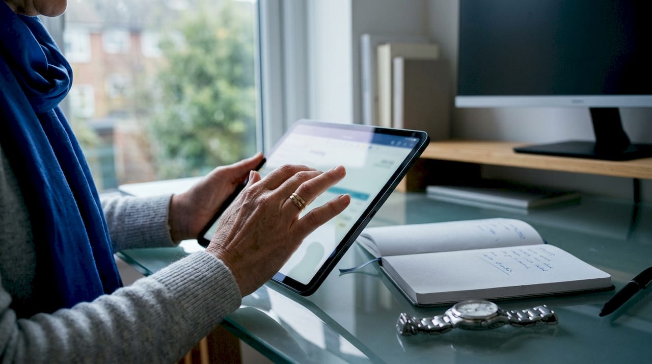 Hands operating invoicing app on tablet indoors
